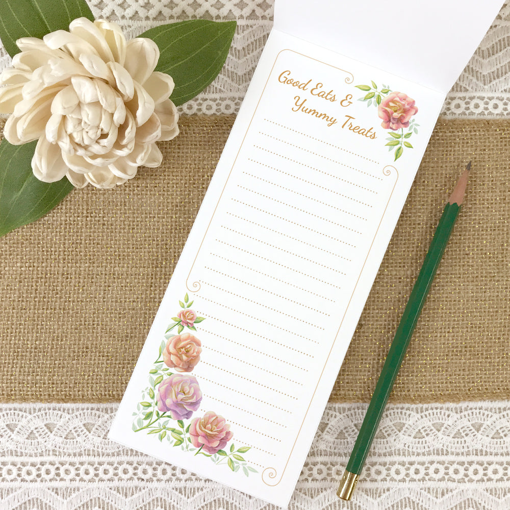 Lined grocery list magnetic notepad with rose border and phrase "Good Eats & Yummy Treats" at the top.